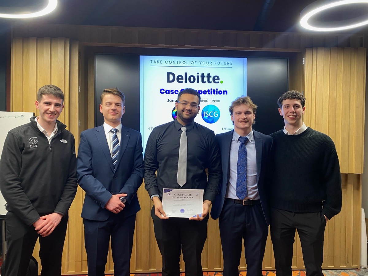 Murtuza holding a certificate with his team at the ISCG x Deloitte Case Competition